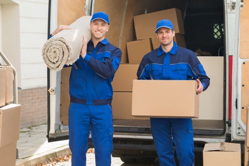 Trained movers carrying furniture carefully during a house move
