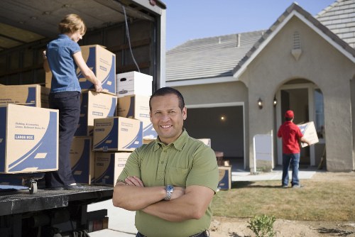 Careful loading of boxes and household items for a flat move in Harrow