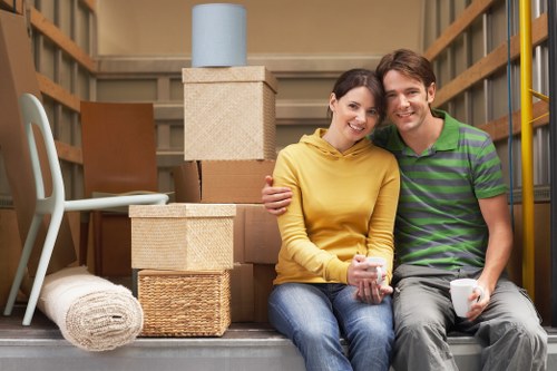 Loading household items into a moving truck for a Harrow relocation