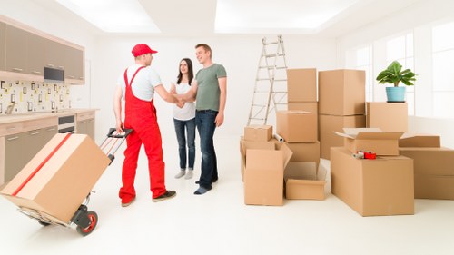 Professional movers handling stairs and narrow access during a Harrow flat move