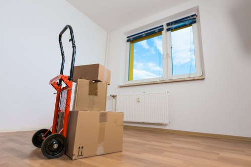 Packed moving boxes and furniture ready for transport during a Harrow house removal